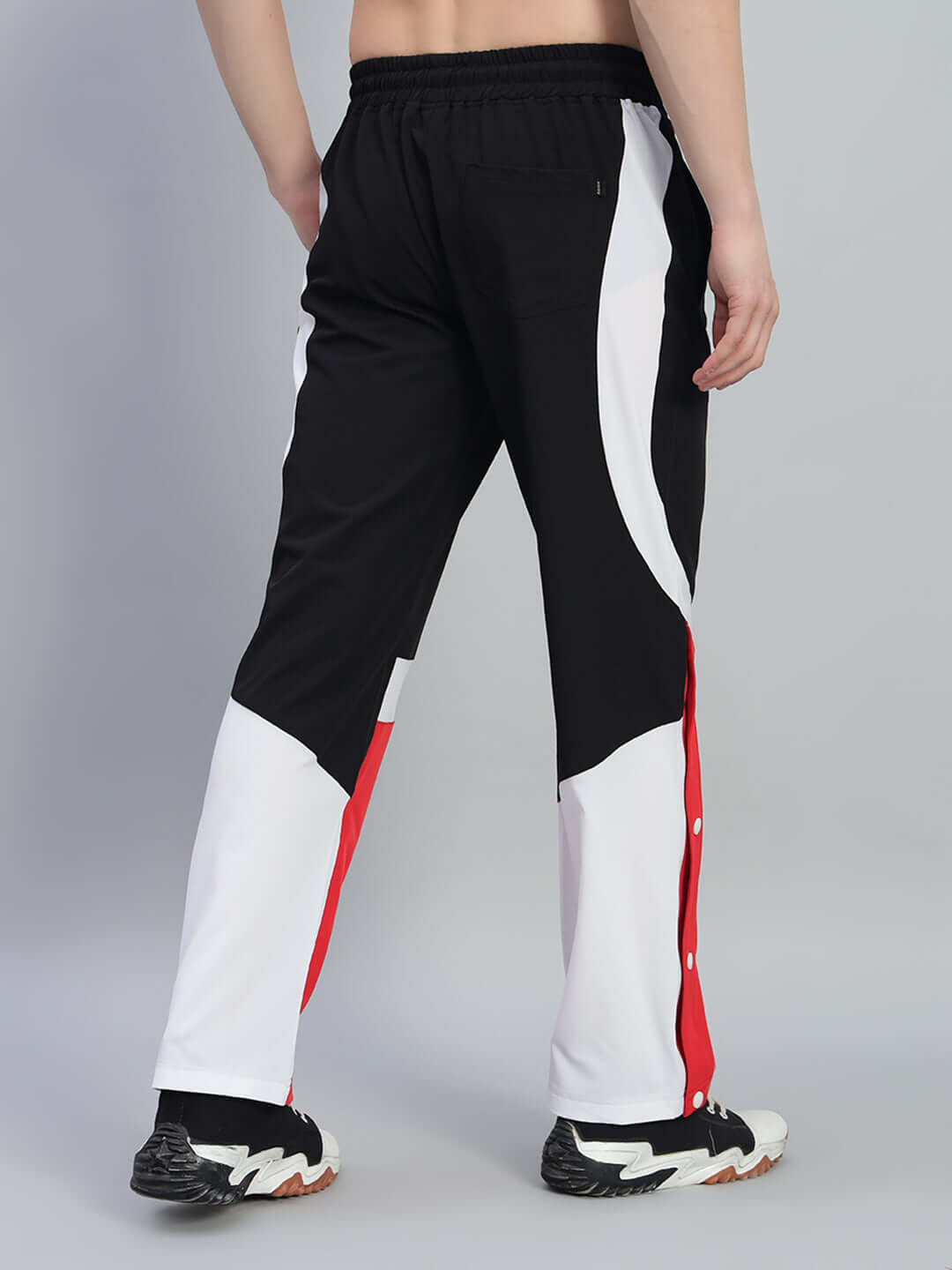 Back view of MARCO RELAXED FIT CARGO PANTS BLACK RED showcasing bold red accents and utility pockets.