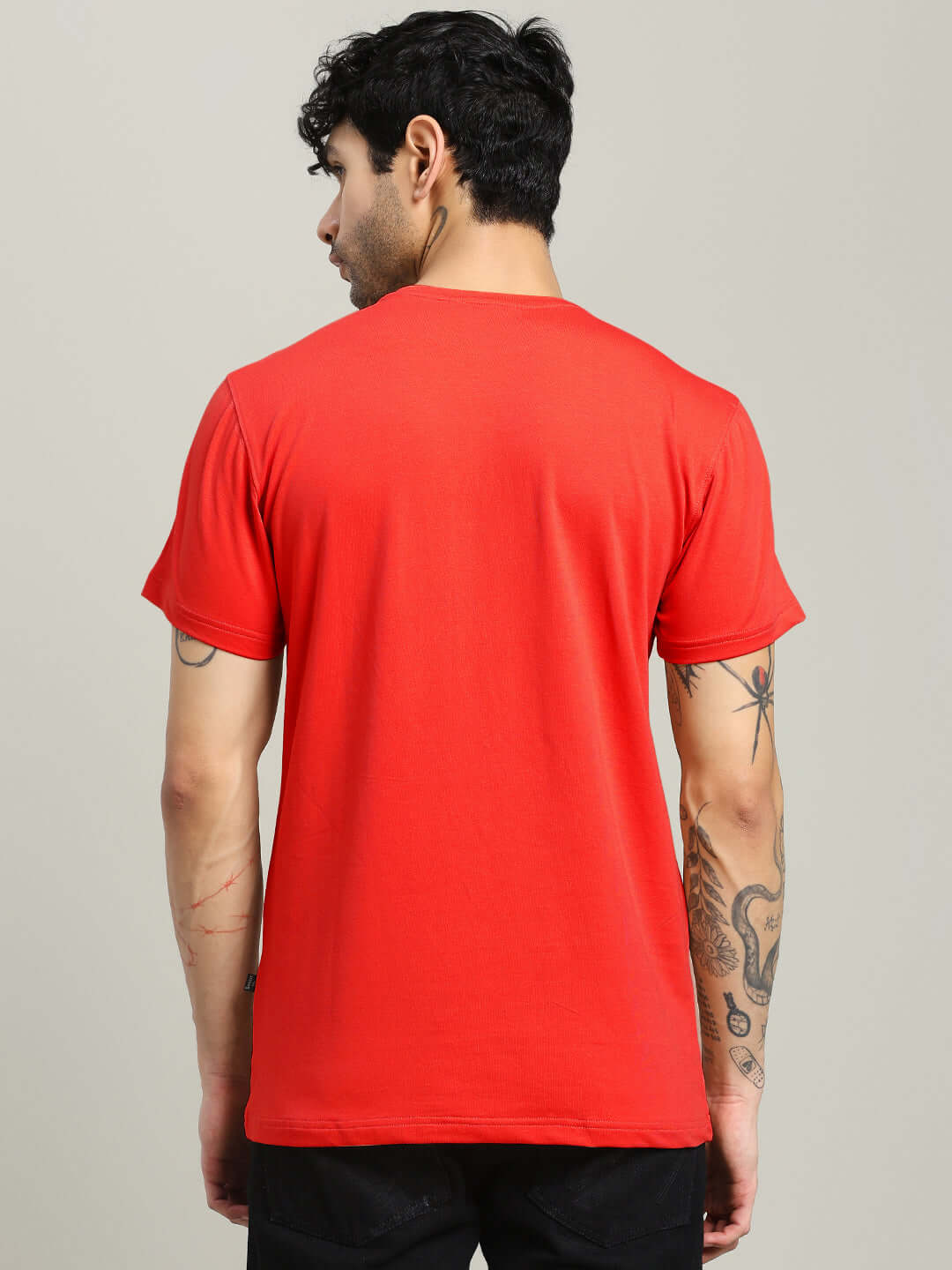 Back view of MARK REGULAR FIT COTTON T-SHIRT RED on model, showcasing vibrant color and casual style.