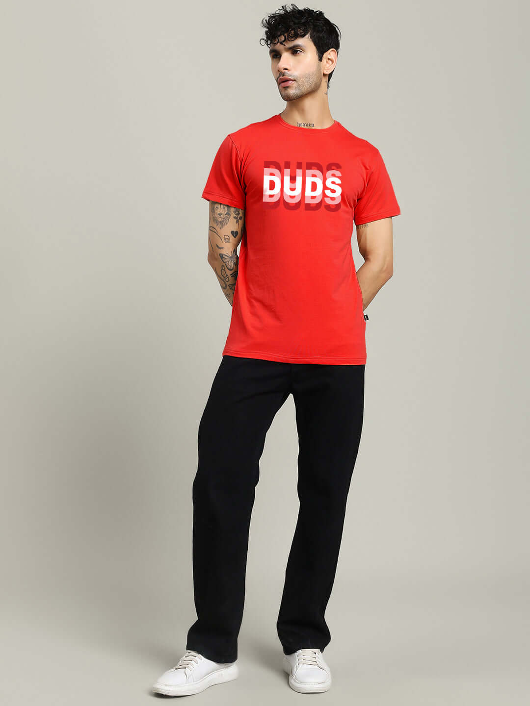 Man wearing MARK REGULAR FIT COTTON T-SHIRT RED with graphic design, paired with black pants, styled for casual look.