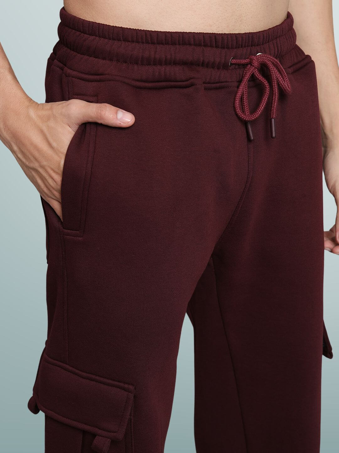 Maroon relaxed fit cargo fleece pants with drawstring waistband and side pockets, showcasing soft and comfortable fabric.
