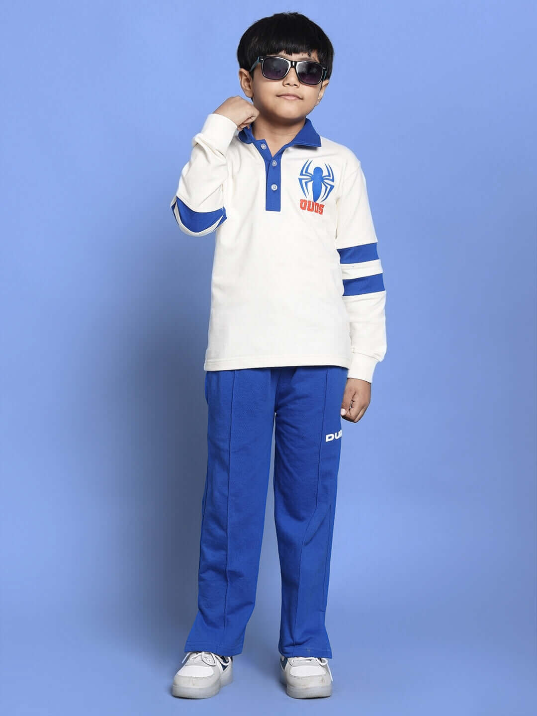 Child wearing Marvel oversized sweatshirt in white and royal blue with stripes, smiling confidently.