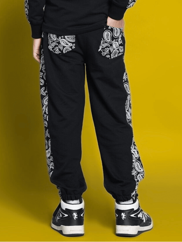Child wearing black Masha joggers with paisley design, suitable for boys and girls. Custom fit option available. Made by DUDS.