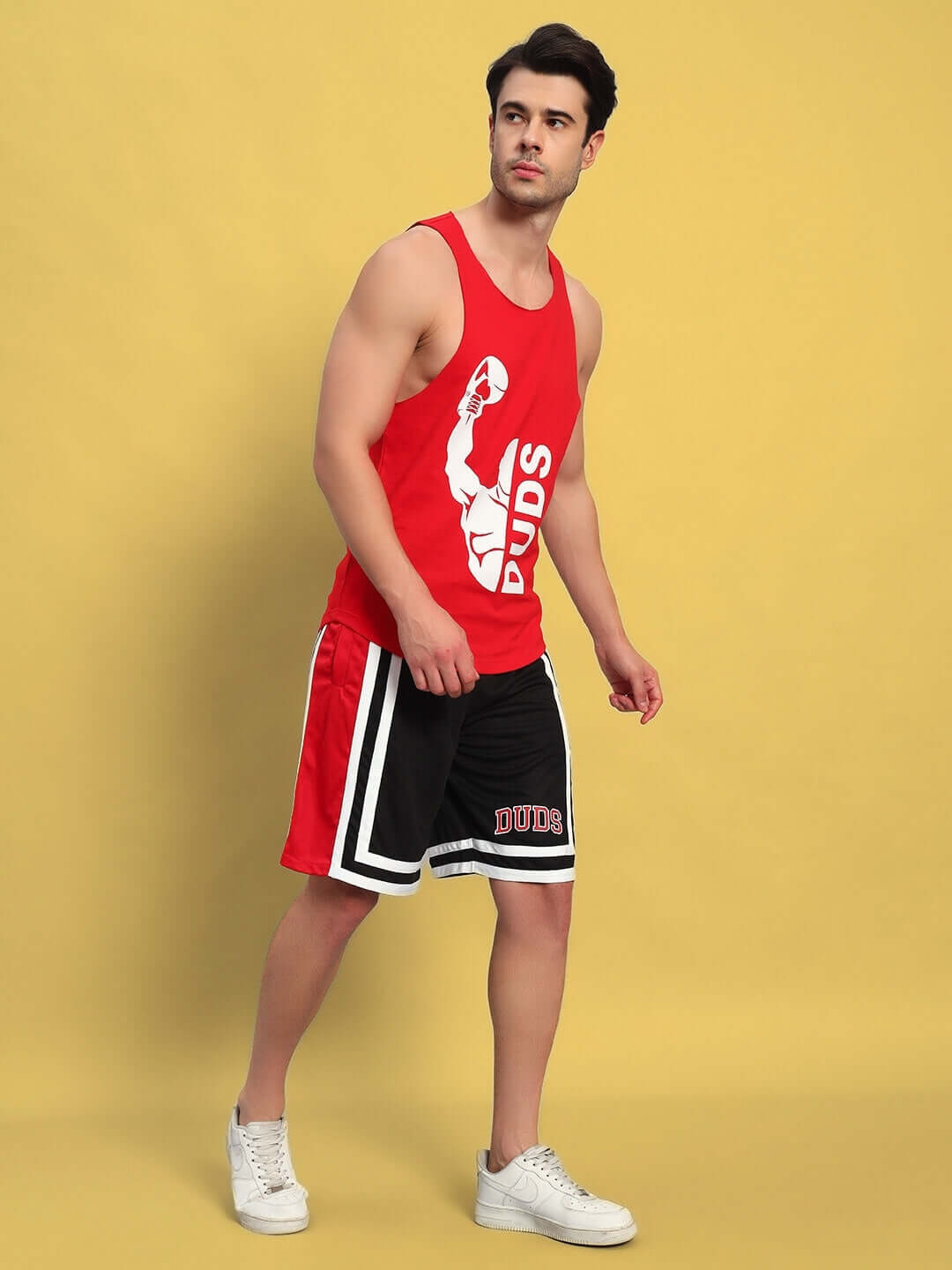 Man wearing MAX GYM COTTON TERRY CO-ORD SET RED-BLACK in athletic pose, showing full outfit against yellow background