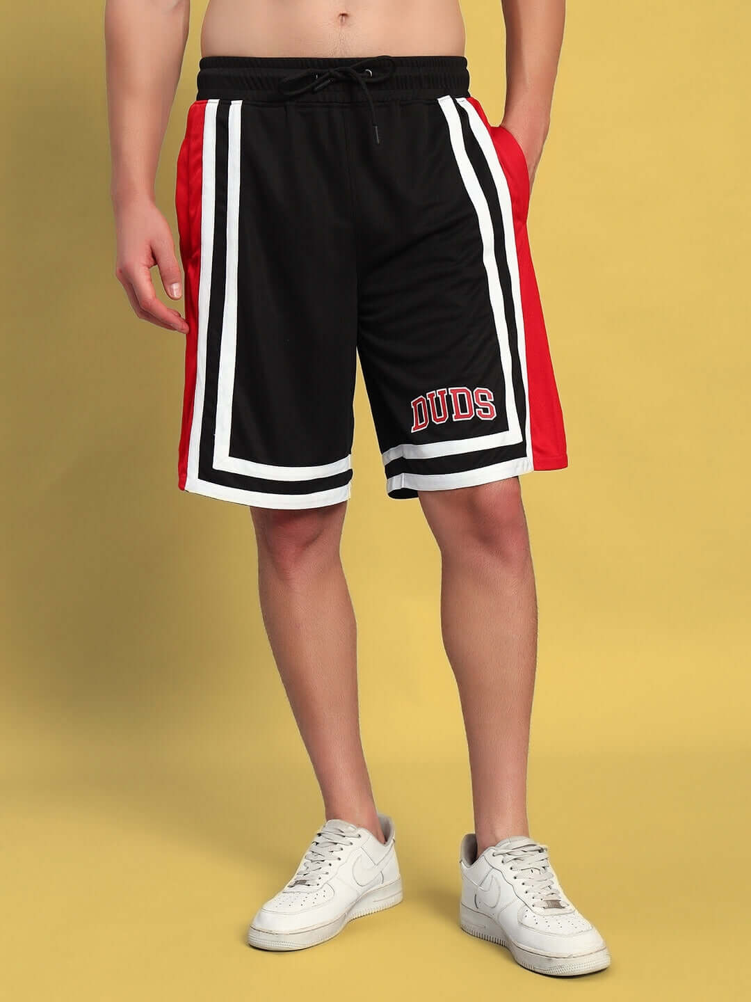 Male model in MAX GYM COTTON TERRY CO-ORD SET RED-BLACK shorts on yellow background