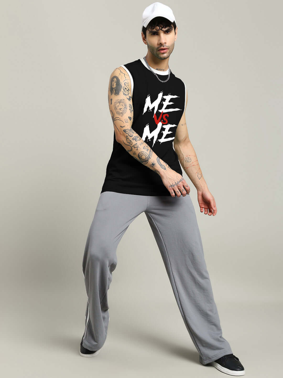 Black 'ME VS ME' gym t-shirt on model showcasing casual workout style.