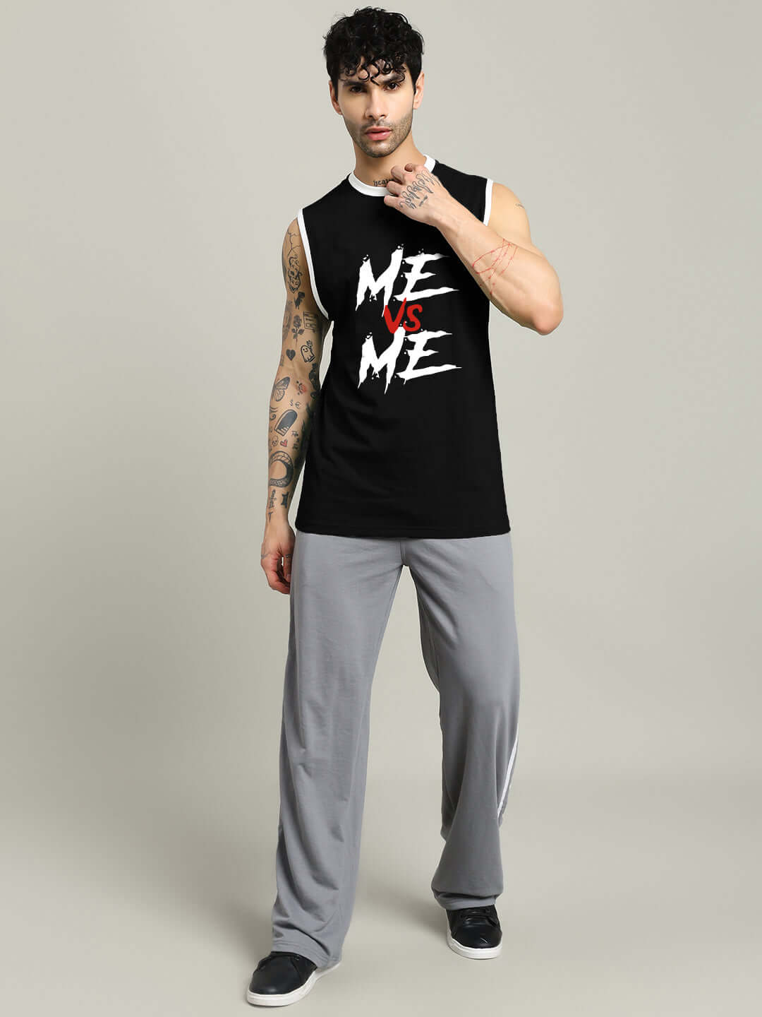 Man wearing black 'ME VS ME' gym t-shirt with custom fit option available, ideal for workouts; image shows front view.