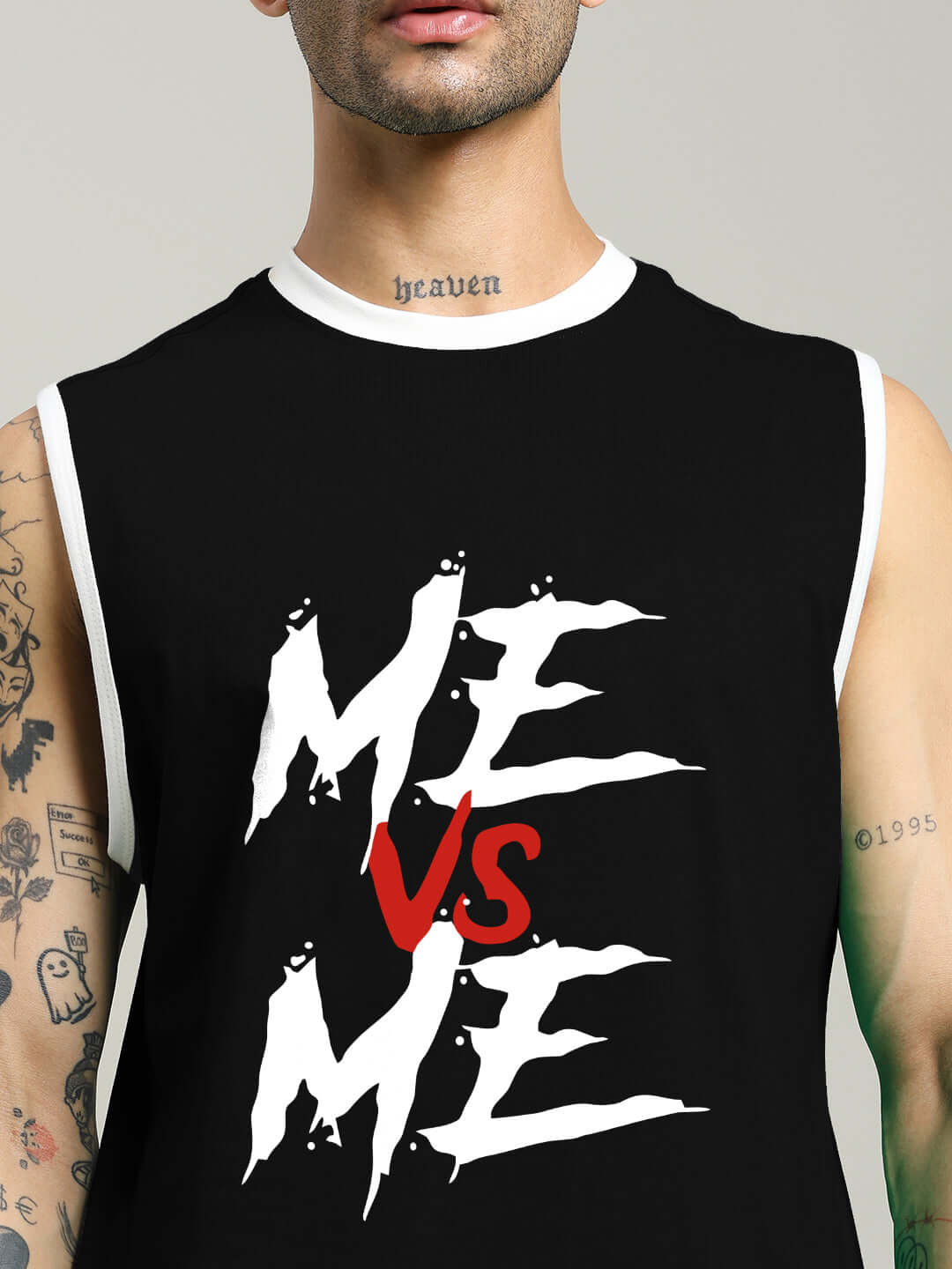 Model wearing black 'ME VS ME' gym t-shirt with bold graphic print, emphasizing personal challenge and fitness mindset.