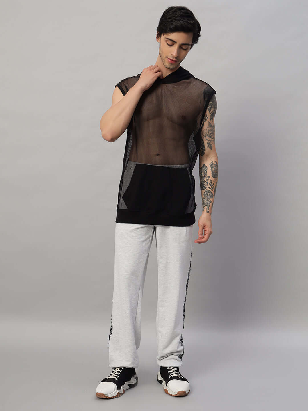 Model wearing BOOGIE OVERSIZED CO-ORD SET MELANGE GREY with sheer top and grey melange pants showcasing streetwear style.