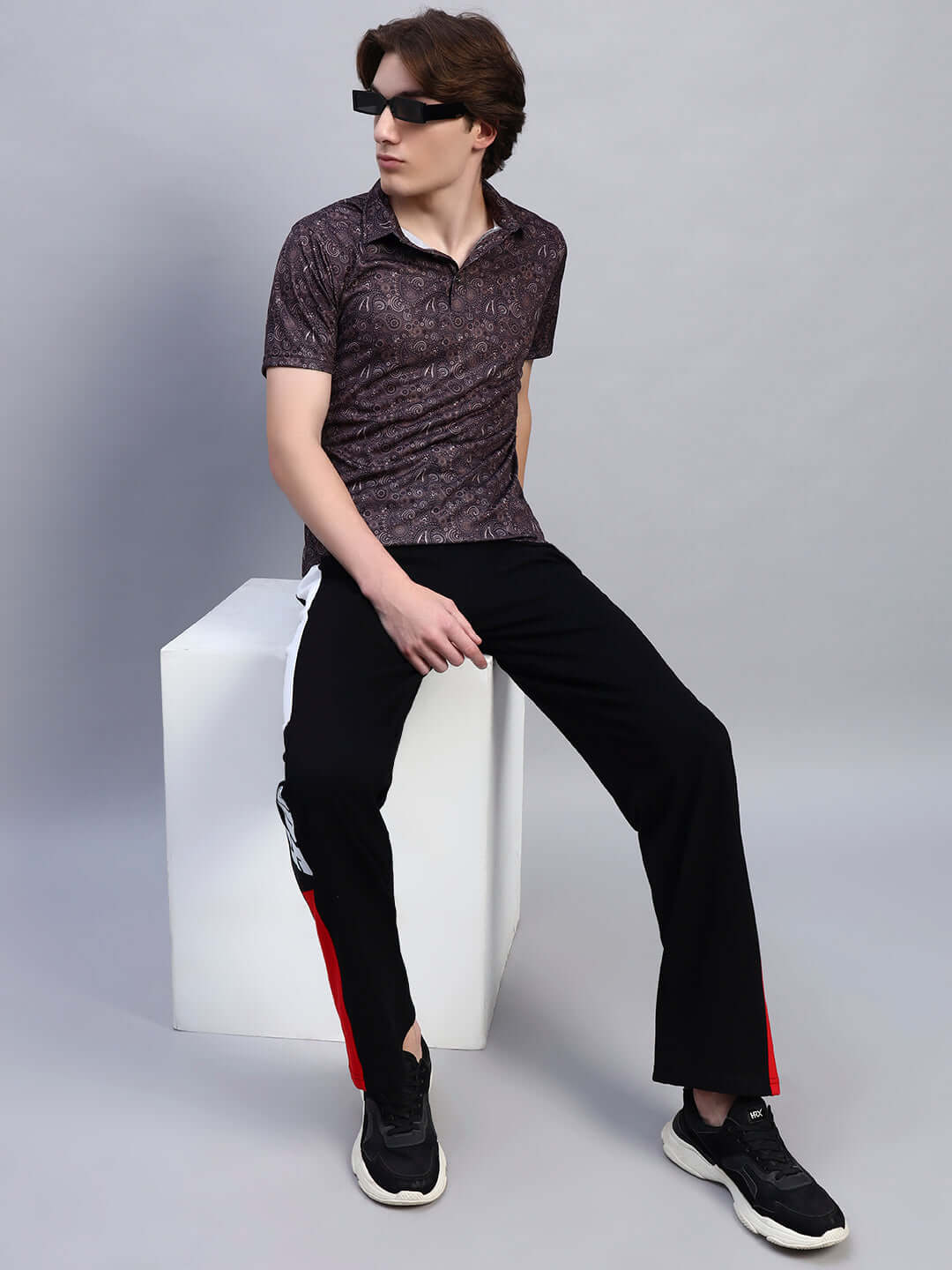 Model wearing a Scottish regular fit brown t-shirt made of sports polyester fabric; stylish casual look.