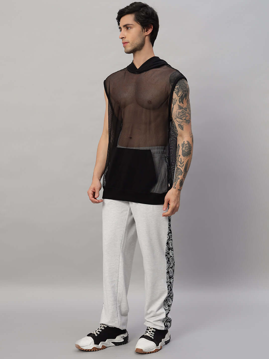 Model wearing BOOGIE OVERSIZED CO-ORD SET MELANGE GREY with sheer black top and grey pants, showcasing a streetwear look.