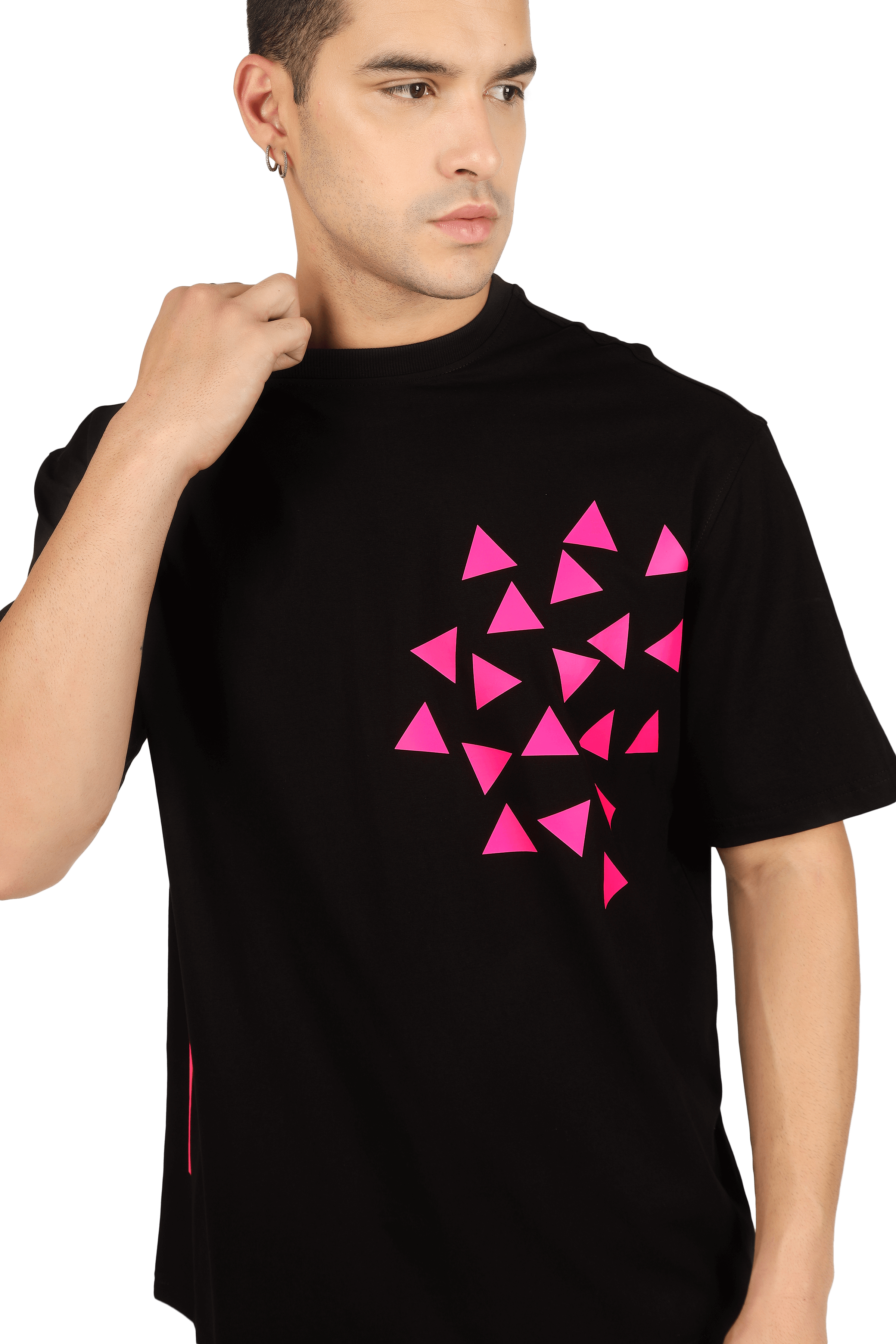 Man wearing black T-shirt with pink geometric design, hand near face.