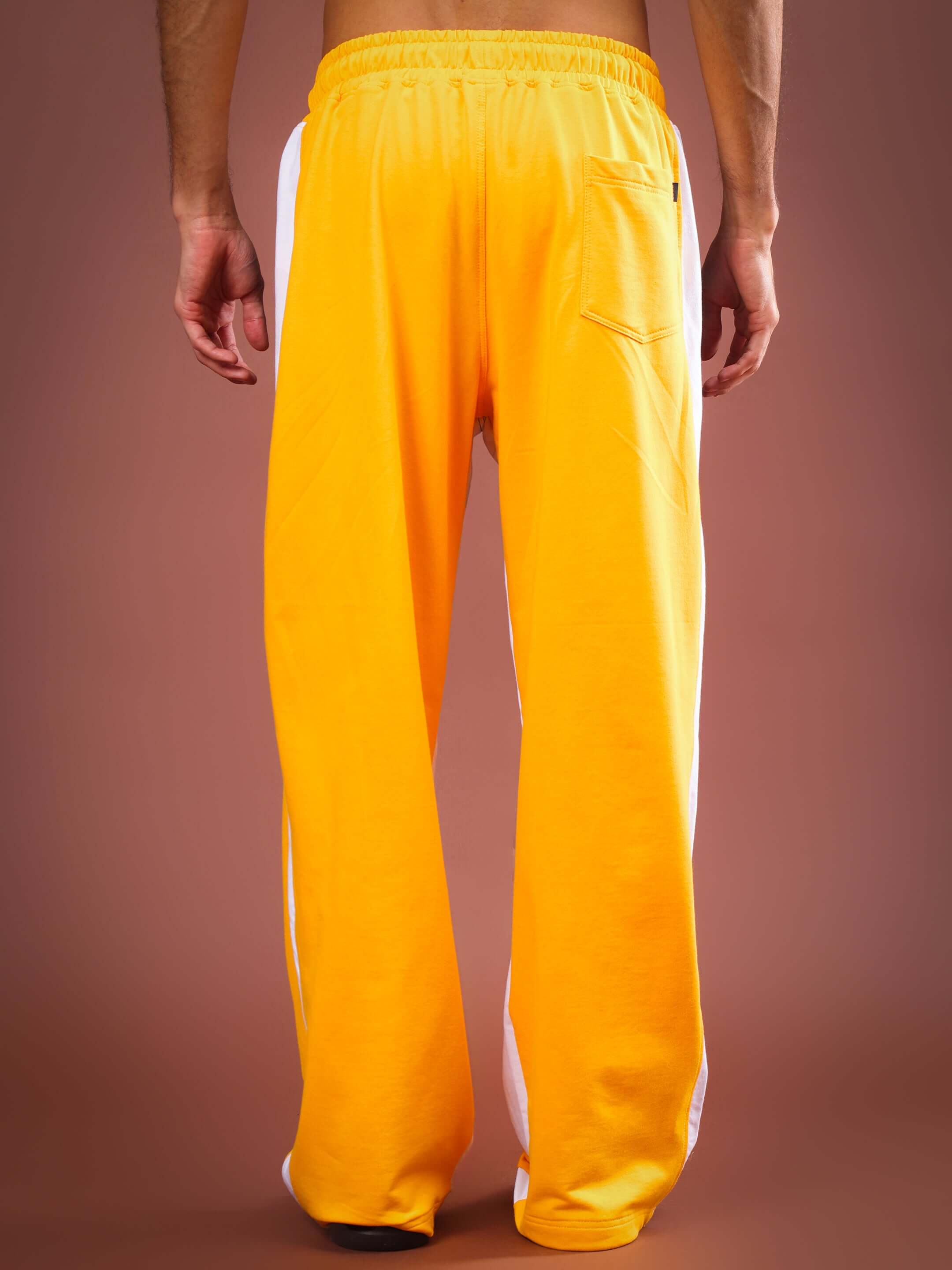 Back view of Meraki Baggy Joggers in yellow-black, showcasing loose fit and stylish design by DUDS.