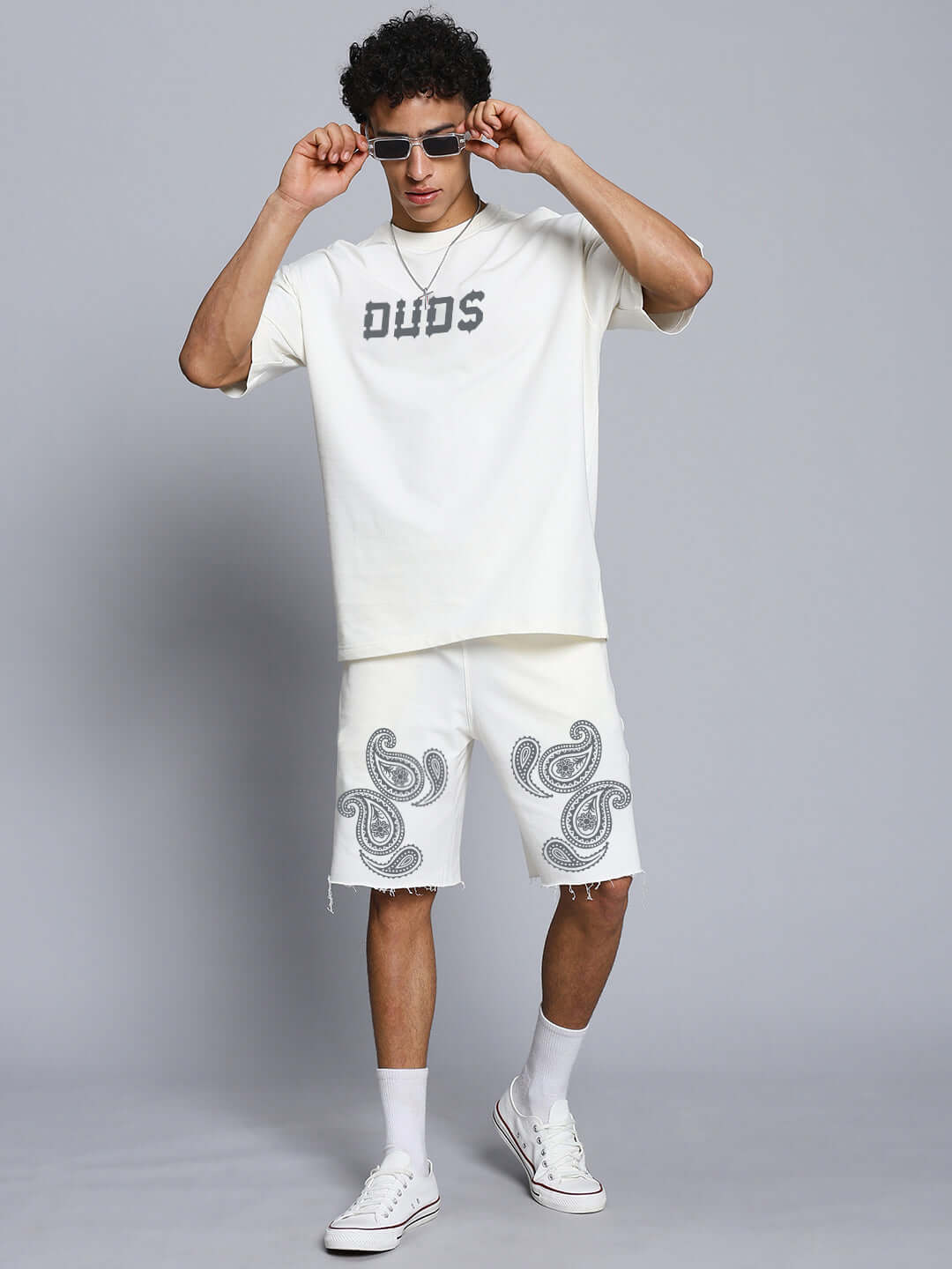 Model wearing the MESSI PAISLEY PRINT CO-ORD SET OFF WHITE, featuring a paisley print t-shirt and matching shorts for casual style.