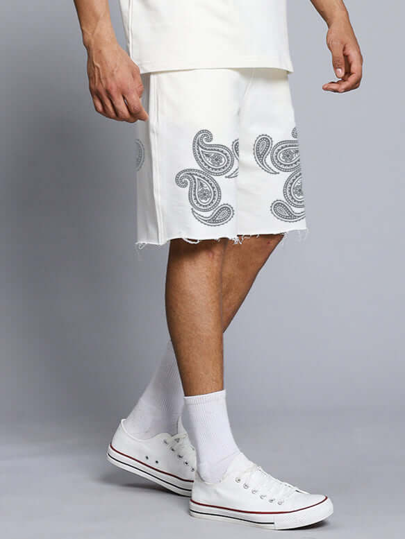 Side view of Messi Paisley Print Regular Fit Shorts Off White with intricate design and white sneakers