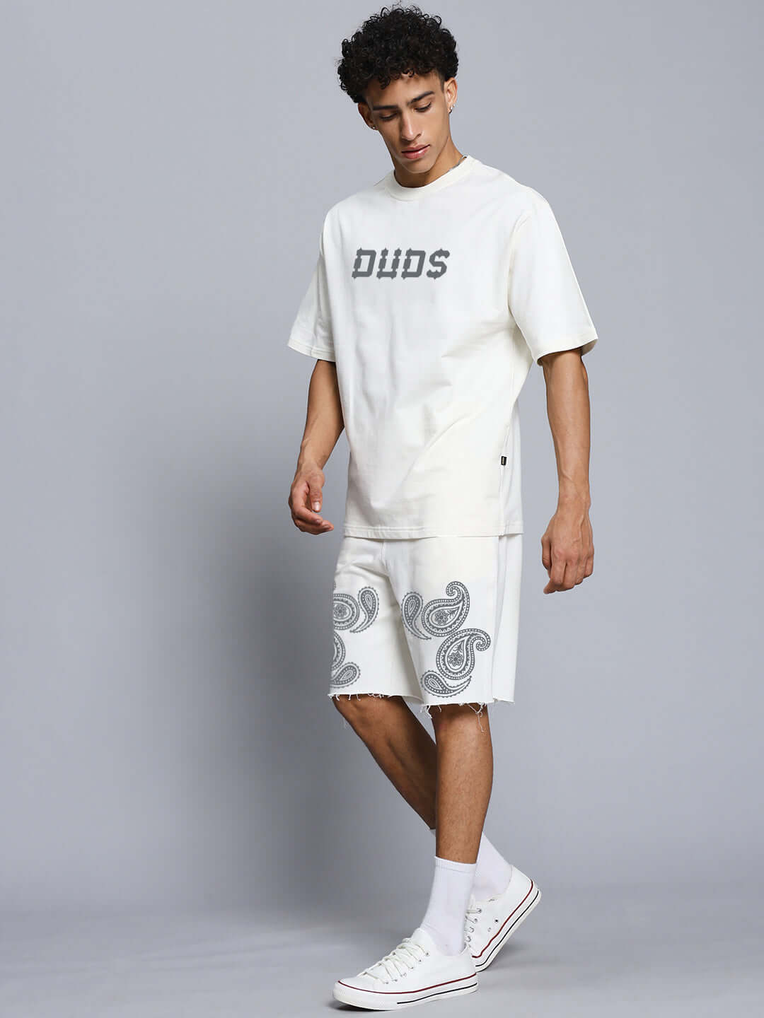 Model wearing Messi Paisley Print Co-Ord Set Off White, featuring oversized paisley print t-shirt and matching shorts.
