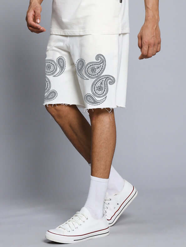 Man wearing Messi Paisley Print Regular Fit Shorts Off White with paisley pattern, styled for casual wear.
