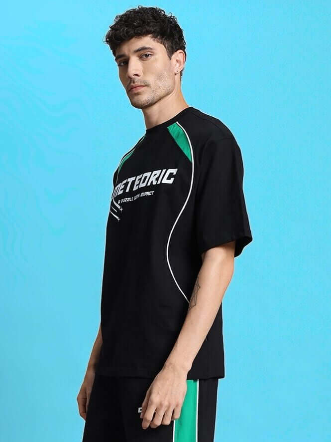 Model wearing METEORIC OVER-SIZED T-SHIRT BLACK in streetwear style