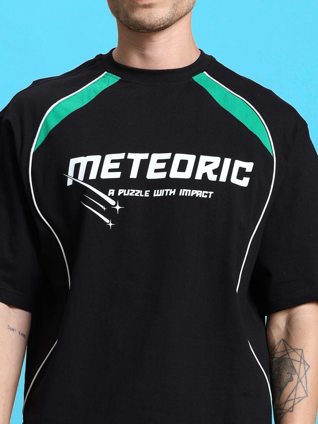 Close-up of a black METEORIC SUMMER CO-ORD SET t-shirt, featuring bold white lettering and sporty green accents.