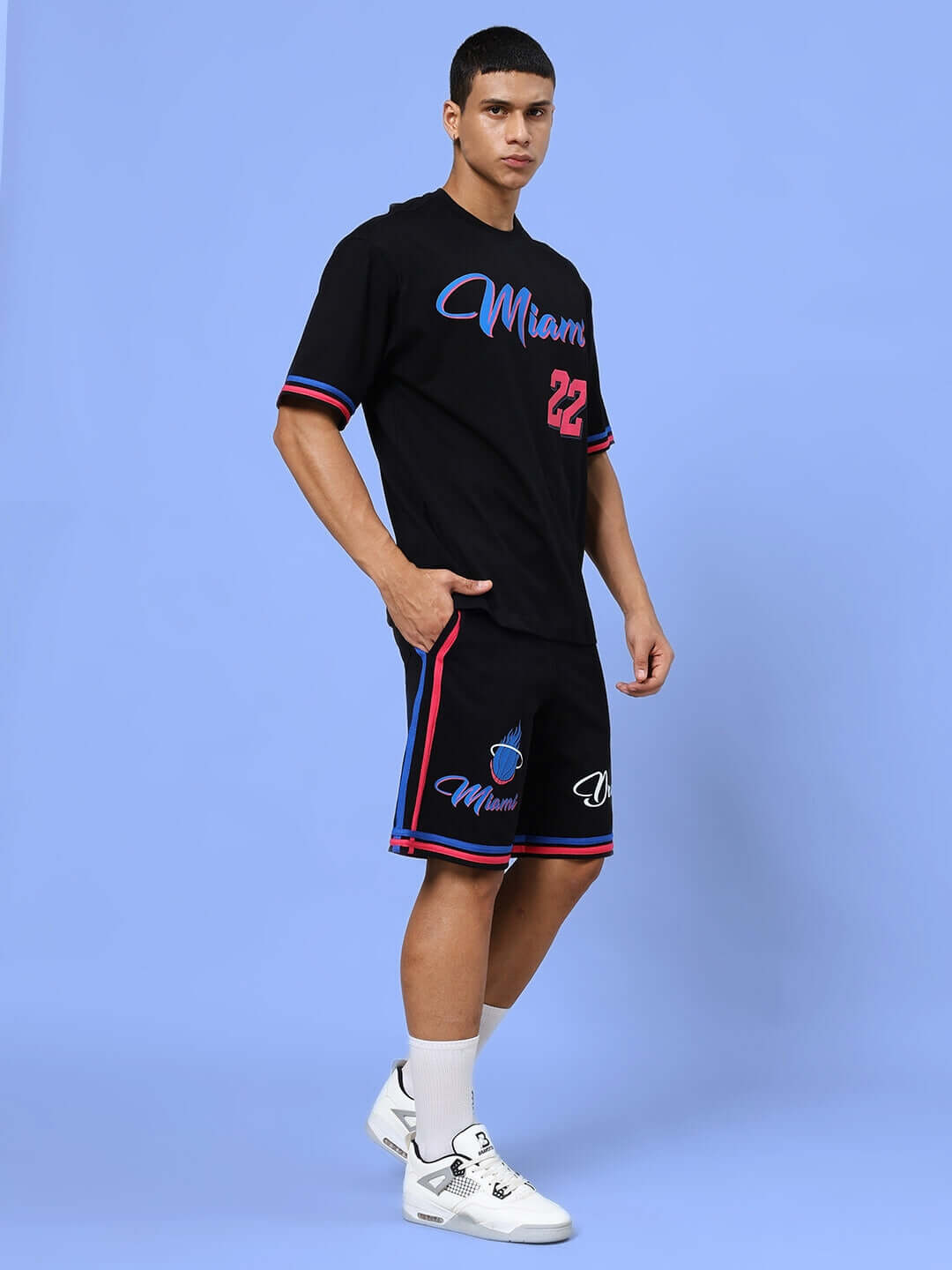 Man wearing MIAMI COLOR BLOCK CO-ORD SET BLACK, featuring a trendy colorblock design with matching joggers and top on a light blue background.