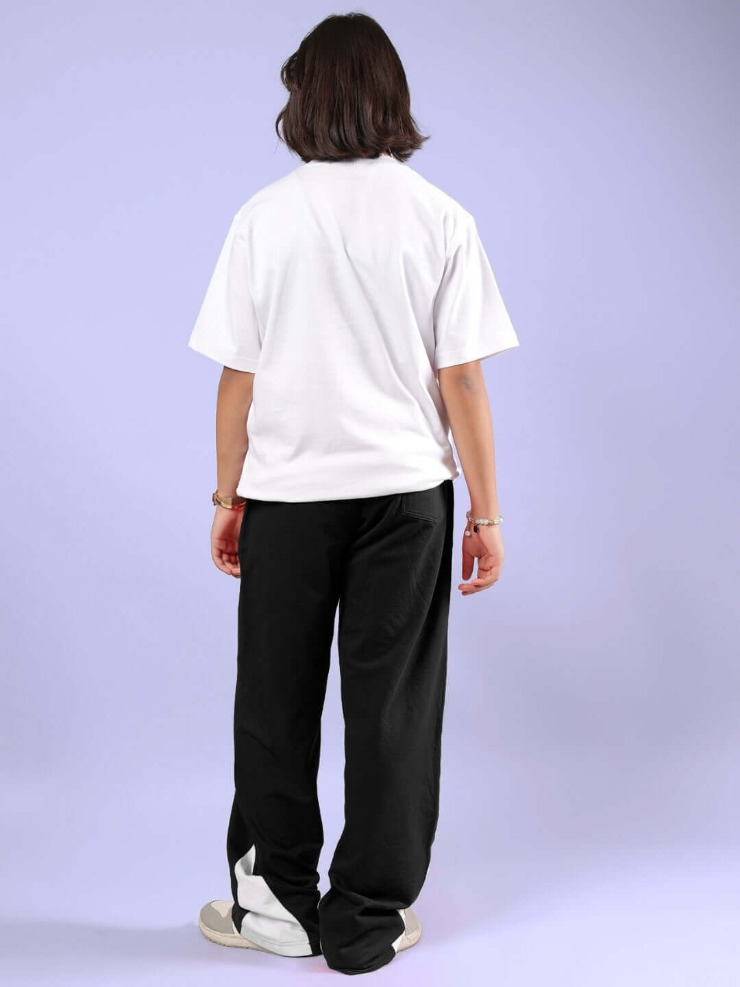 Rear view of child wearing MICKEY AND FRIENDS CO-ORD FOR BOYS & GIRLS WHITE-BLACK featuring white T-shirt and black joggers.