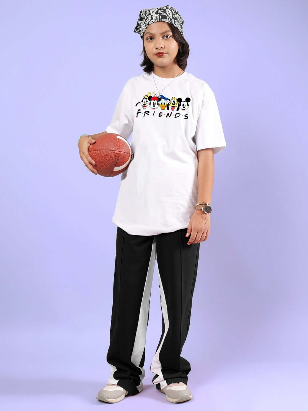 Child wearing MICKEY AND FRIENDS CO-ORD FOR BOYS & GIRLS WHITE-BLACK holding a basketball.