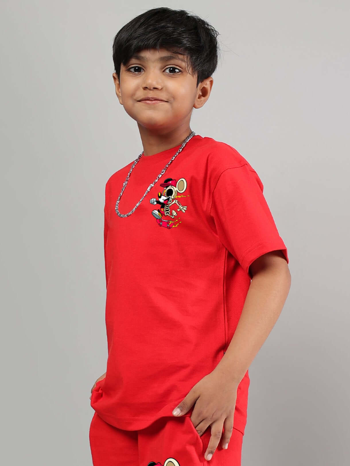 Boy wearing a red Mickey Mouse summer t-shirt designed for boys and girls by DUDS.