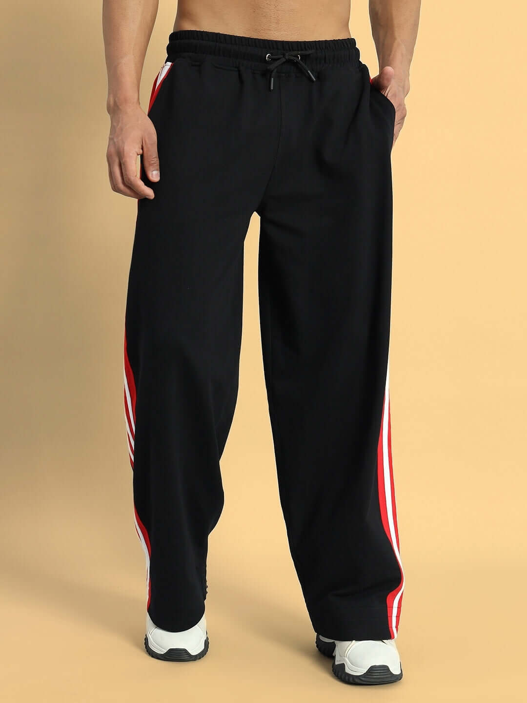 MILANO RELAXED-FIT COTTON JOGGERS BLACK-RED Man wearing Milano Relaxed-Fit Joggers in Black-Red with side stripes, showcasing comfortable style and custom fit options.