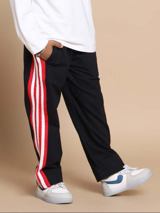 MILANO RELAXED PANT FOR BOYS & GIRLS JOGGER BLACK RED Child wearing Milano Relaxed Pant Jogger for boys and girls in black with red stripes, showcasing casual style and comfort.
