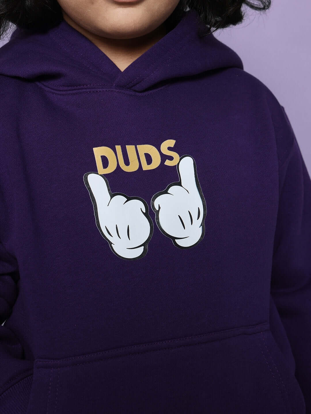 Child wearing a purple hoodie with cartoon hands and 'DUDS' text, part of the MILLER CO-ORD FOR BOYS GIRLS PURPLE set.