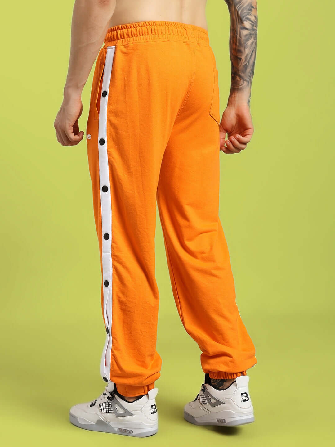 Back view of MILLER RELAXED FIT JOGGERS ORANGE with button detail, highlighting premium cotton blend fabric, ensuring style and comfort.