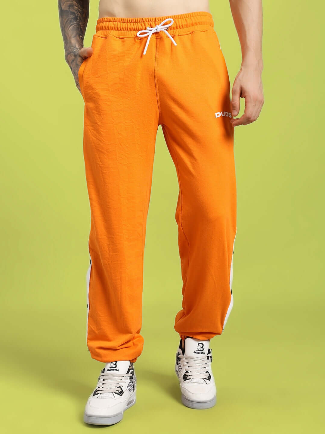 MILLER RELAXED FIT JOGGERS ORANGE showcasing bold streetwear style with premium comfort on model.