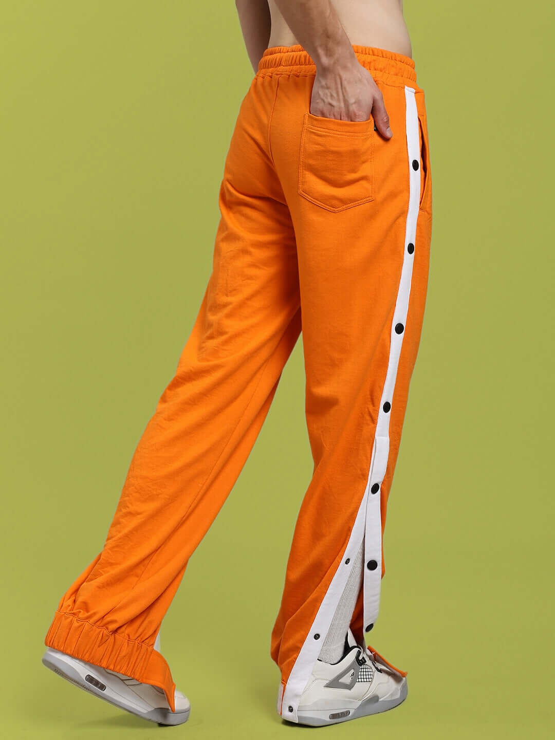MILLER RELAXED FIT JOGGERS ORANGE with side buttons and white stripes, showcasing premium cotton blend fabric and casual style.