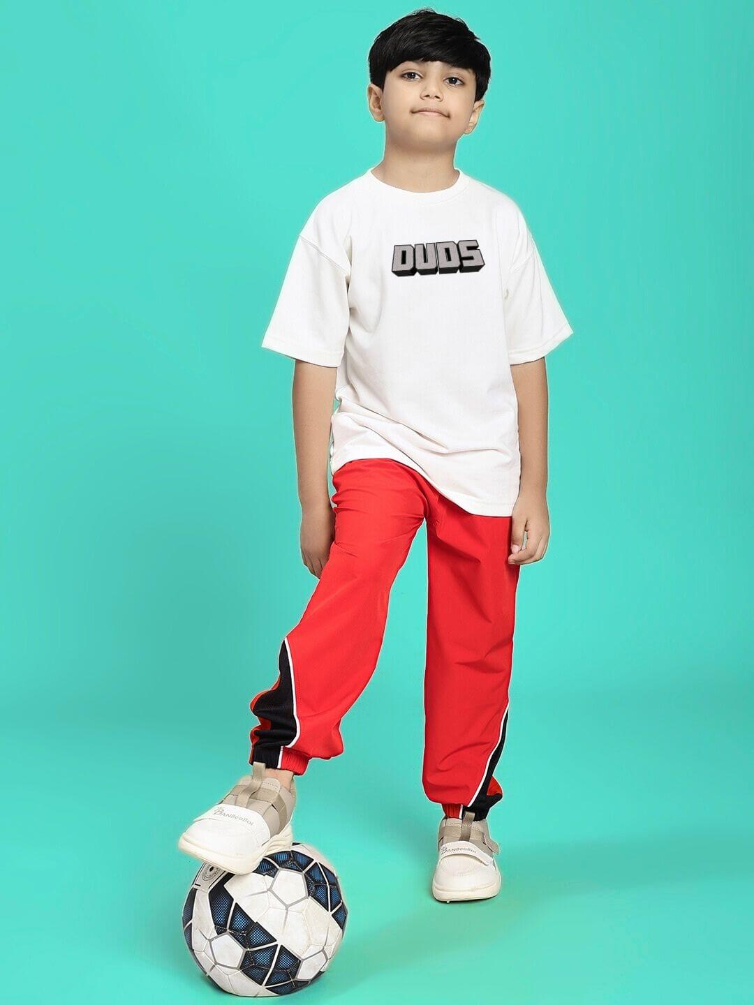 Child wearing Minecraft T-shirt for boys girls white with soccer ball and red pants, ideal for young gamers seeking everyday style.