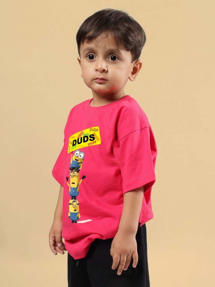 Young child wearing a Minion Cartoon T-Shirt for boys and girls pink, perfect for kids who love playful style.