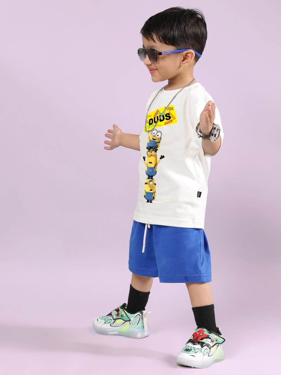 Child wearing Minion Cartoon T-Shirt for Boys and Girls Off White, enjoying playful style perfect for kids' activities.