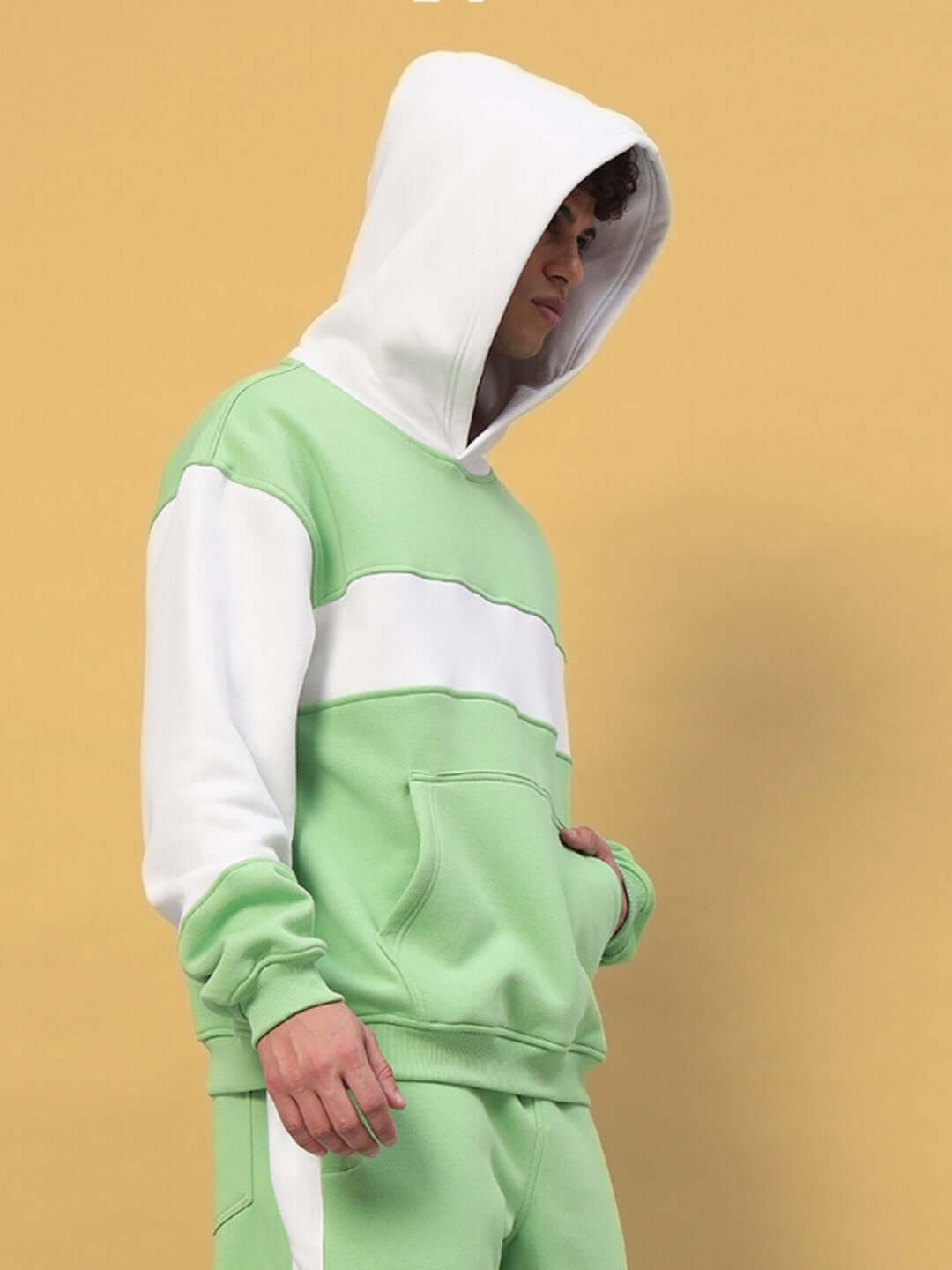 Minted Bliss colorblock hoodie in green and white, worn by a model, showcasing casual fashion style.