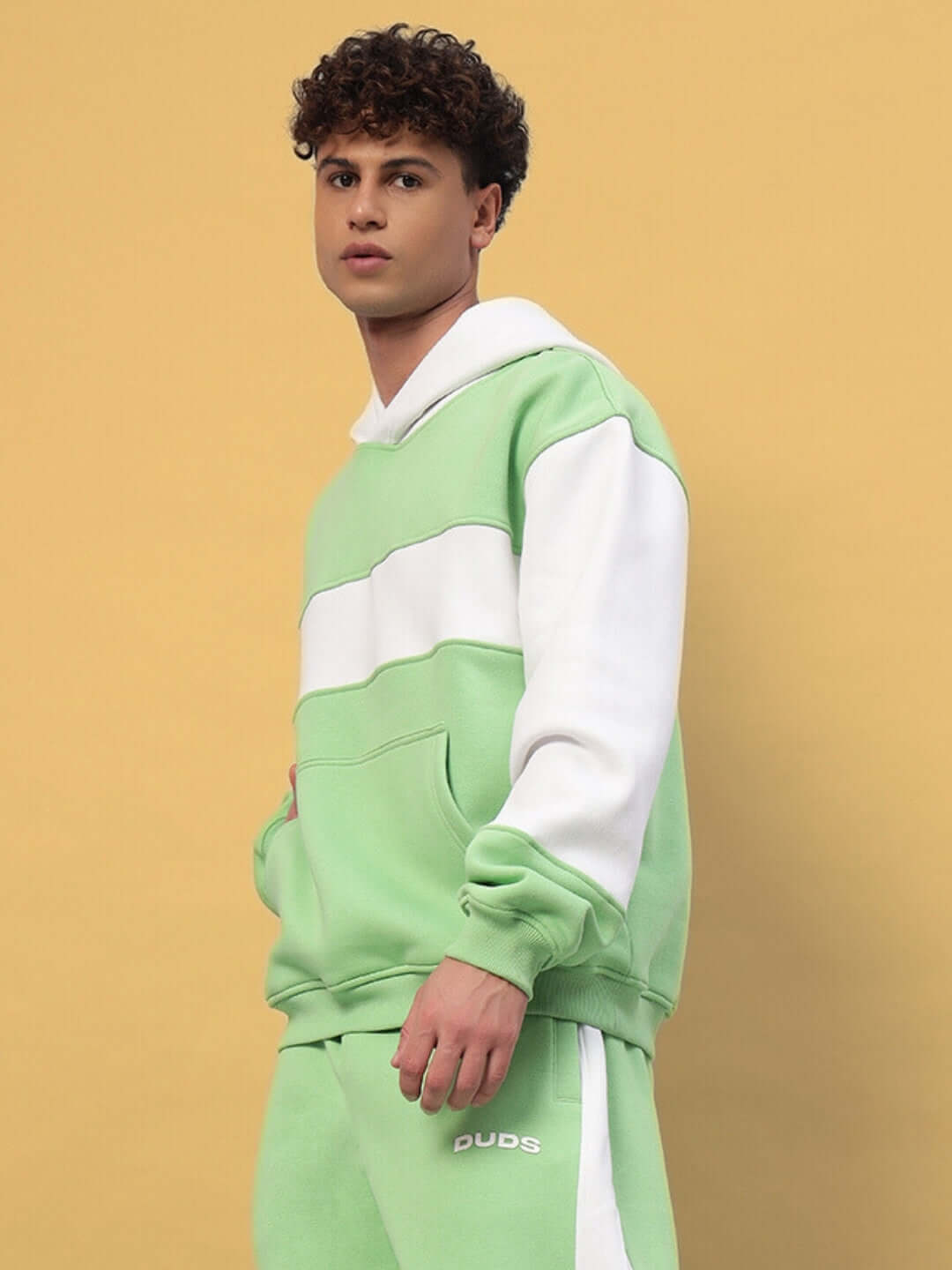 Minted Bliss colorblock hoodie in green and white worn by model, side view