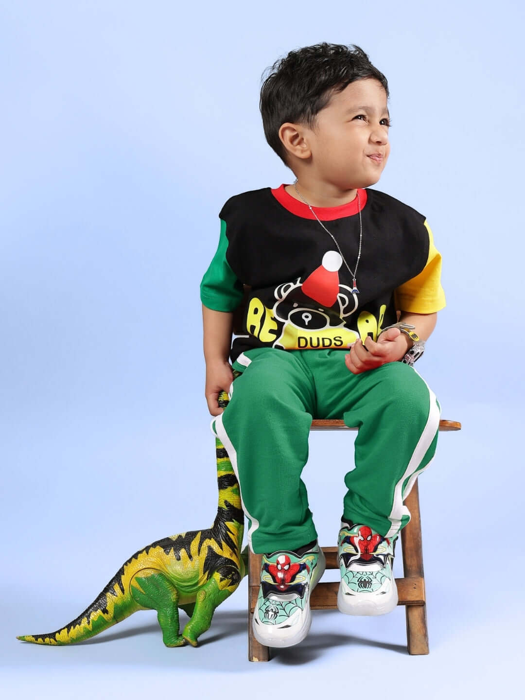 Child wearing MOCHA CO-ORD FOR BOYS & GIRLS BLACK GREEN outfit with playful design.