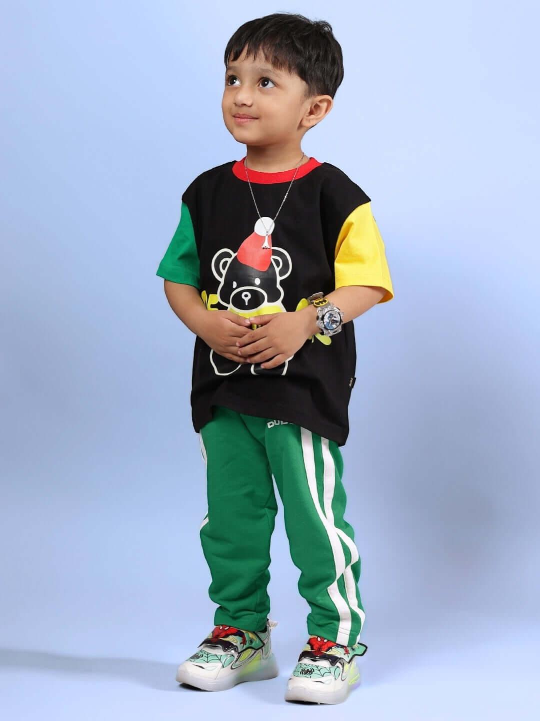 Child wearing MOCHA CO-ORD FOR BOYS & GIRLS BLACK GREEN outfit, featuring colorful top and green pants.