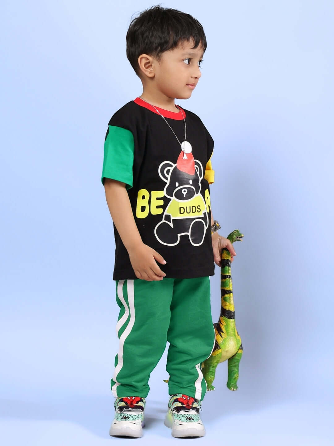 MOCHA CO-ORD FOR BOYS & GIRLS BLACK GREEN outfit worn by a child holding a toy dinosaur, featuring black and green colors.