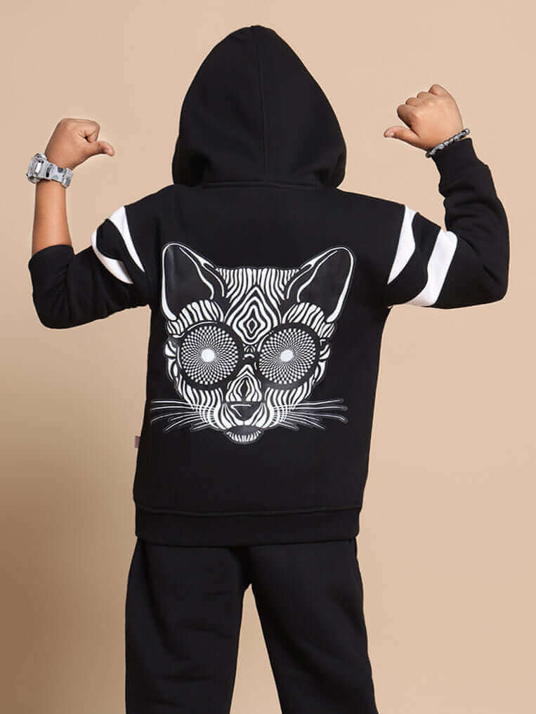 Child wearing black MOLLY oversized hoodie featuring unique animal design, showcasing back view with arms raised.