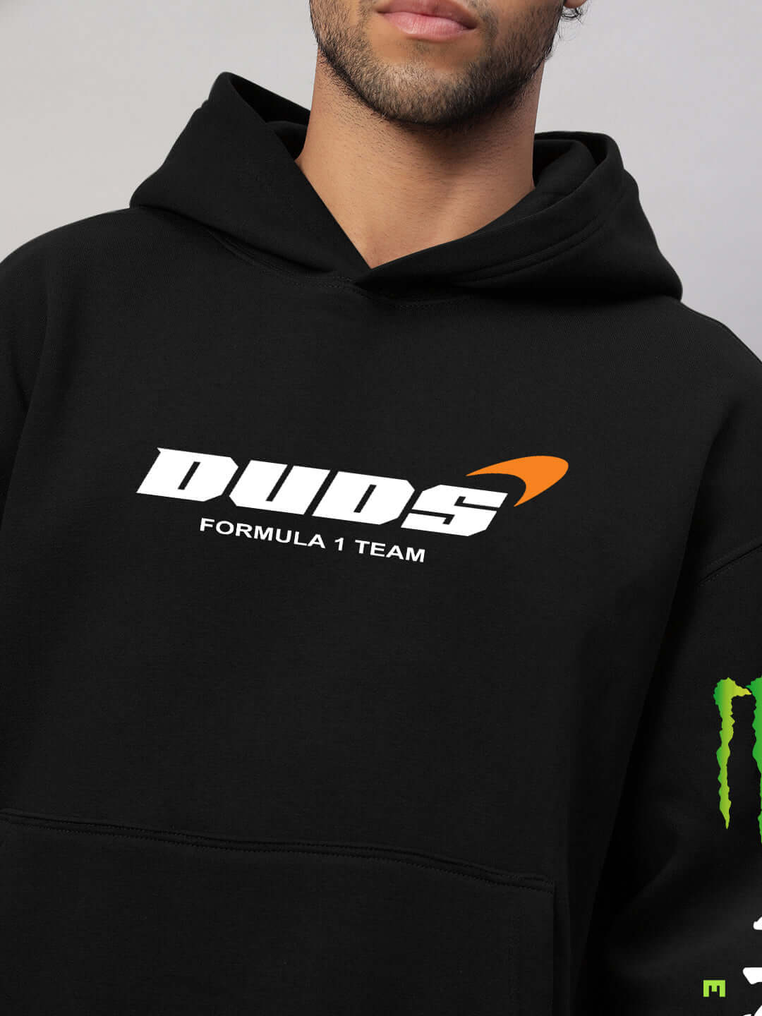 Man wearing MONSTER DRINK FLEECE HOODIE BLACK with DUDS Formula 1 Team logo