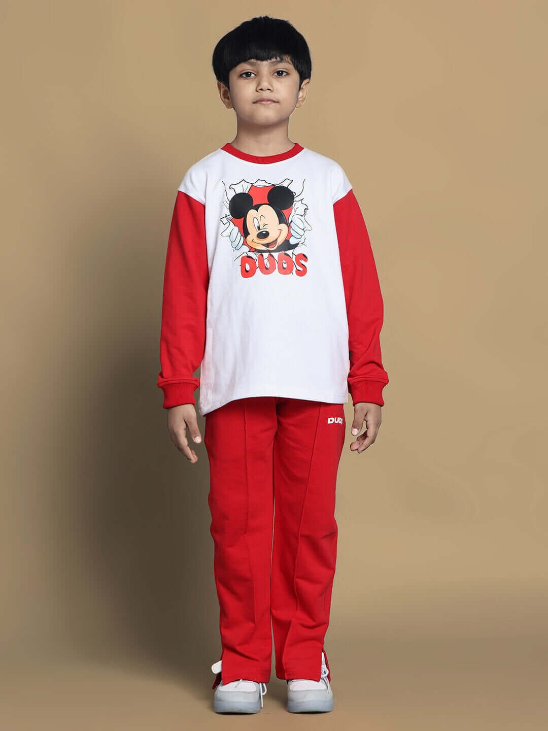 Child wearing Mortimer oversized co-ord set, white and red, unisex relaxed fit joggers with elasticated waistband and drawstring.