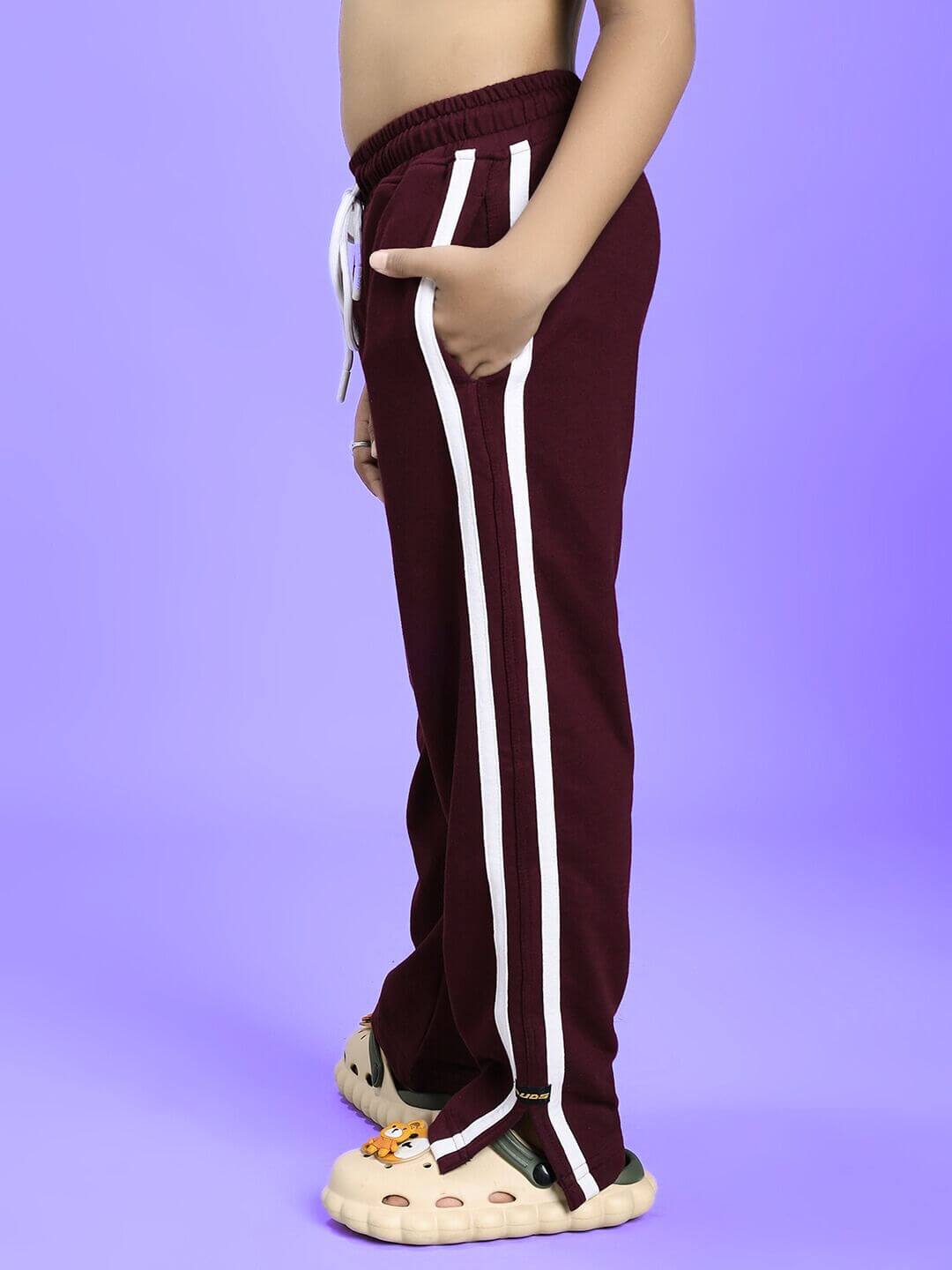 Child wearing MOSCOW RELAXED FIT JOGGER FOR BOYS AND GIRLS MAROON with side stripes, shown from the side. Activewear fashion for kids.