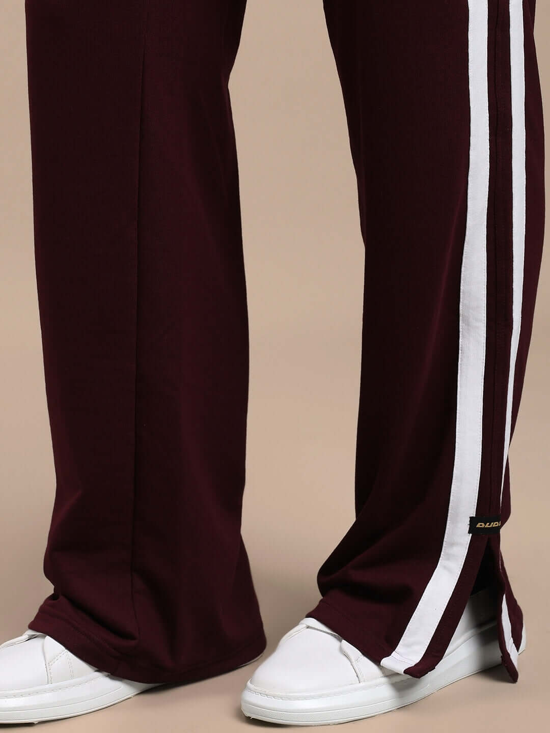MOSCOW RELAXED FIT JOGGERS MAROON shown with white sneakers, highlighting their premium fabric and deep maroon color for stylish comfort.