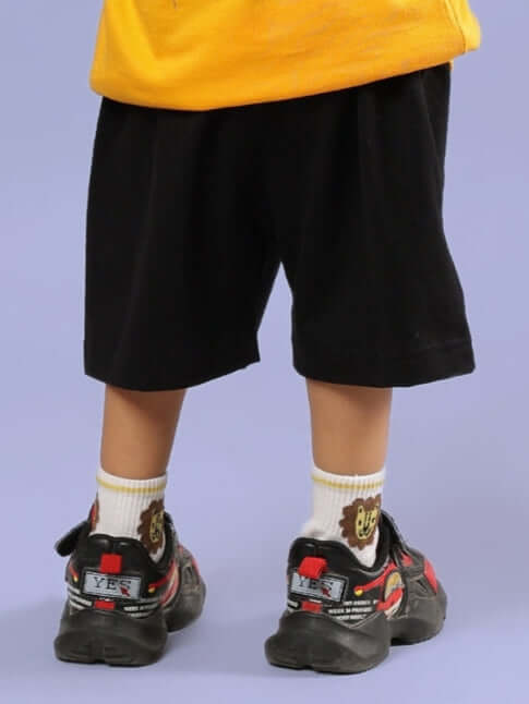 Child wearing MUFASA SHORTS FOR BOYS & GIRLS BLACK, showcasing comfortable and stylish design suitable for everyday wear.