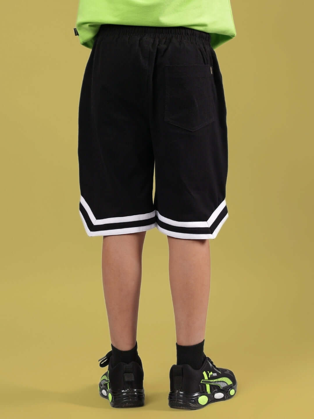 Back view of MUFFIN SHORTS FOR BOYS & GIRLS BLACK with stylish trim, showcasing unique design for kids.