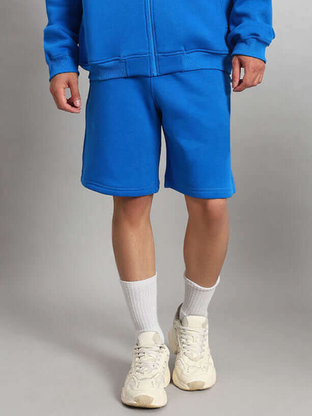 Model wearing Muppet Duds Fleece Co-ord in Blue showing off the cozy and stylish shorts and top ensemble.