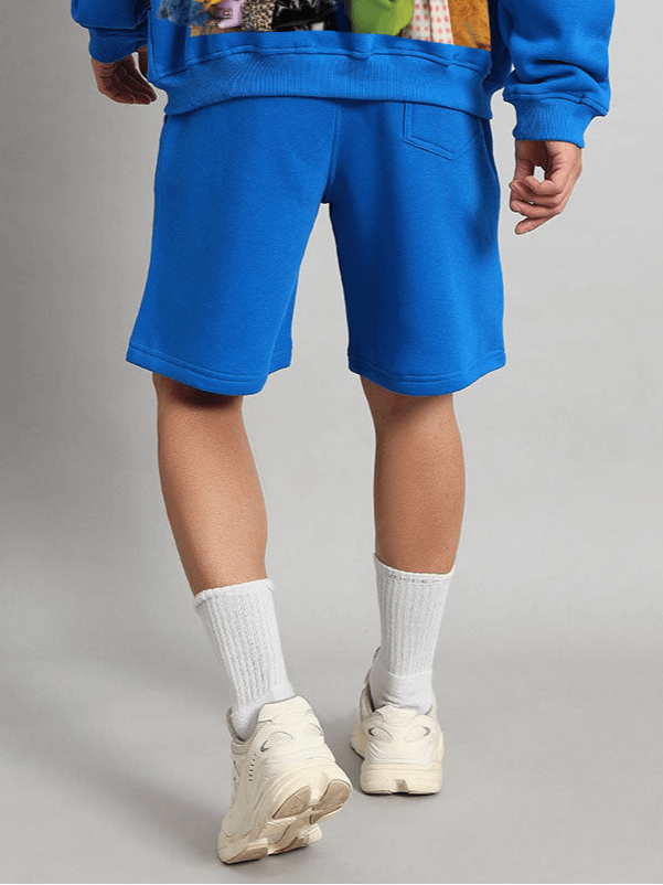 Person wearing Muppet Duds Fleece Shorts in Blue, showcasing vibrant color and relaxed fit for casual and comfortable style.