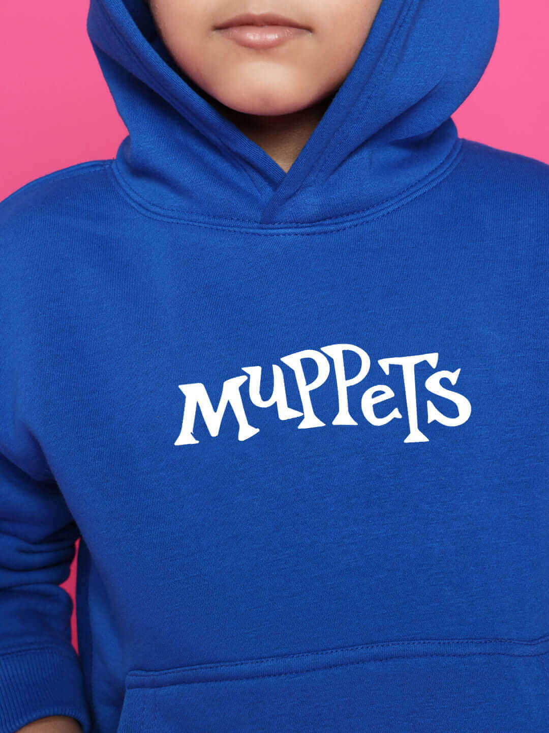 Child wearing a blue Muppets hoodie with pink background, part of the Muppets Co-Ord collection for boys & girls by DUDS.